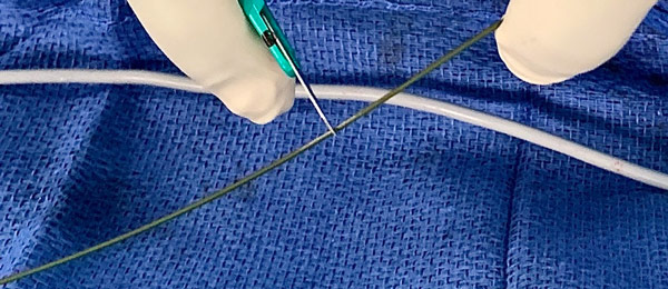Scrape a portion of the wire with a scalpel to better expose the metal core