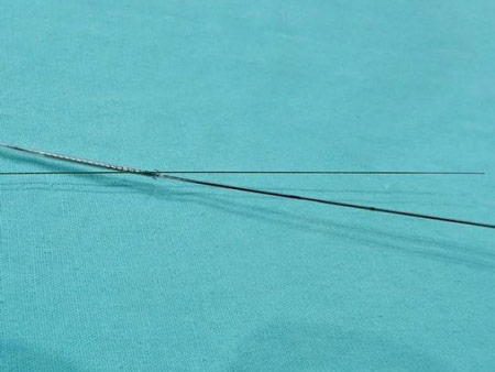 Gently and carefully (avoiding damaging the stent balloon) cross the opened cell
